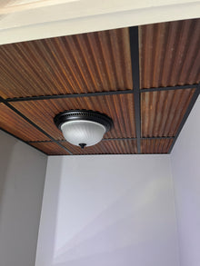 Custom cut corrugated metal ceiling tiles in commercial application